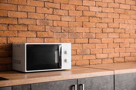 Modern microwave oven in kitchenの写真素材