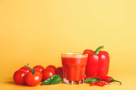Glass of fresh vegetable juice on color backgroundの写真素材