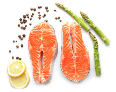 Raw salmon steaks and spices on white backgroundの写真素材