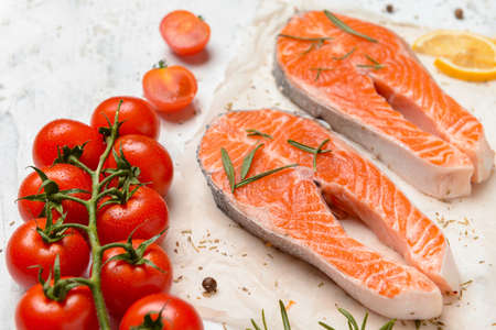 Composition with raw salmon steaks on tableの写真素材