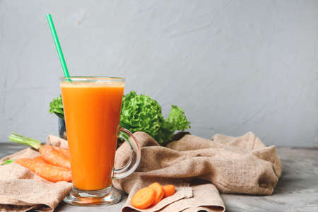 Glass of fresh carrot juice on tableの写真素材