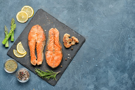 Composition with fried salmon on tableの写真素材