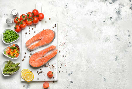 Composition with raw salmon steaks on tableの写真素材