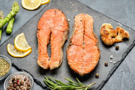 Composition with fried salmon on tableの写真素材