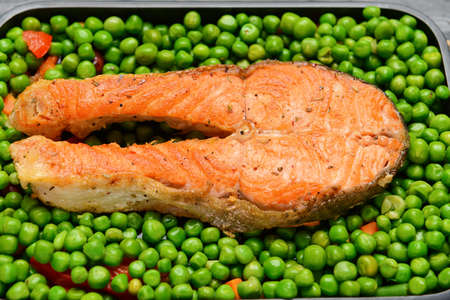 Tasty salmon and peas in baking dishの写真素材