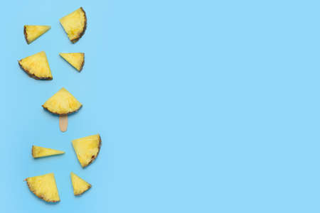 Composition with fresh cut pineapple on color backgroundの写真素材