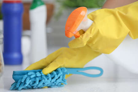 Young woman cleaning her kitchen