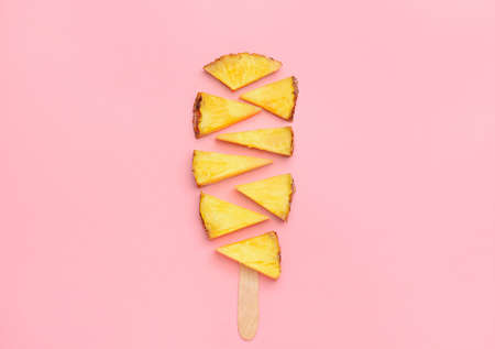 Composition with fresh cut pineapple on color backgroundの写真素材