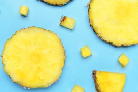 Fresh cut pineapple on color backgroundの写真素材