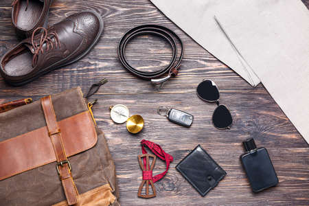 Set of male accessories on wooden background