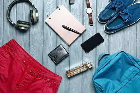 Set of male clothes and accessories on wooden background