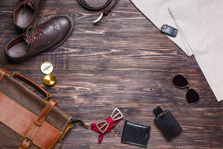 Set of male accessories on wooden background