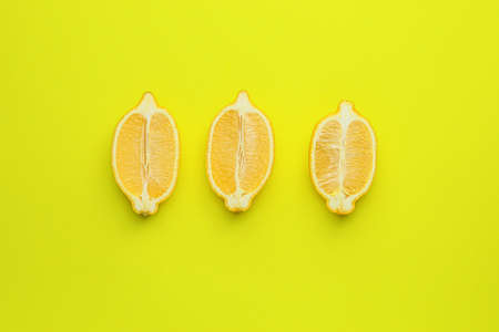 Ripe cut lemons on color backgroundの写真素材