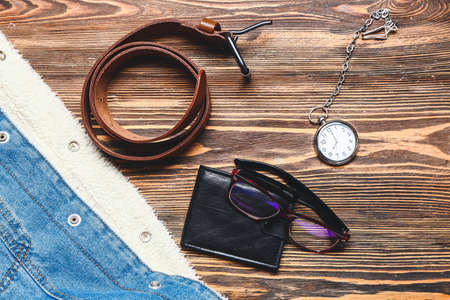 Set of male clothes and accessories on wooden background