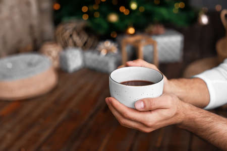 Man with cup of hot chocolate at home, closeupの写真素材