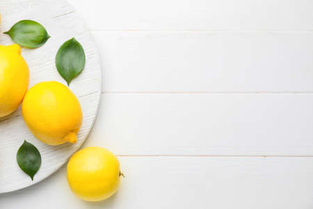 Fresh ripe lemons on white tableの写真素材