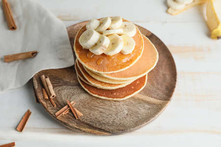Plate with stack of tasty pancakes on tableの写真素材