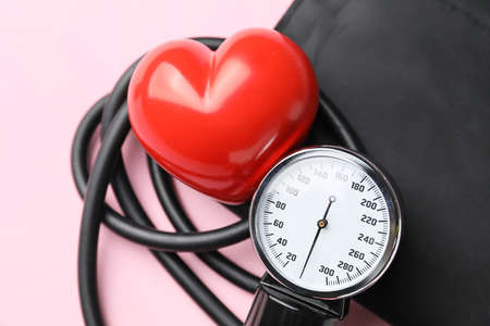 Sphygmomanometer with red heart on color background, closeupの写真素材