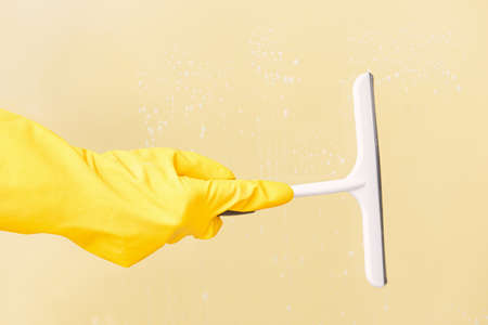 Woman cleaning window at homeの写真素材