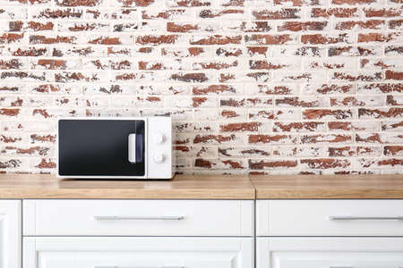 Modern microwave oven in kitchenの写真素材