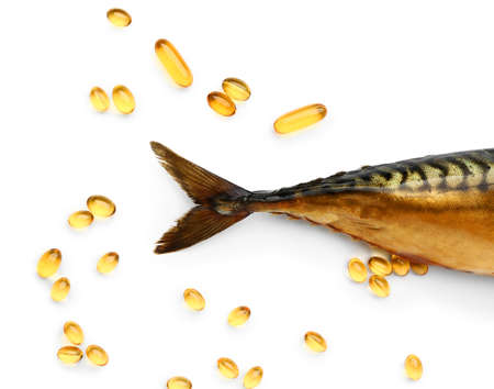 Fish with oil pills on white backgroundの写真素材