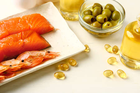 Set of healthy products with high omega 3 and fish oil pills on white tableの写真素材