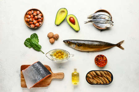Set of healthy products with high omega 3 and fish oil pills on white background