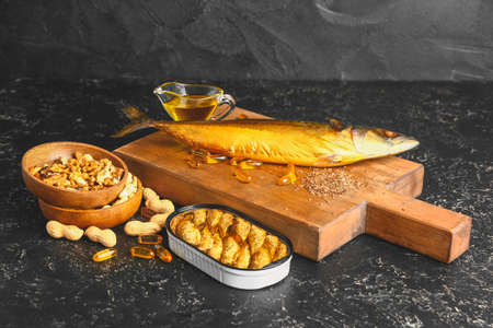 Set of healthy products with high omega 3 and fish oil pills on dark backgroundの写真素材