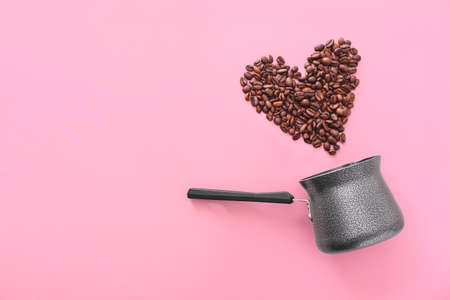 Jezve and heart made of coffee beans on color backgroundの写真素材