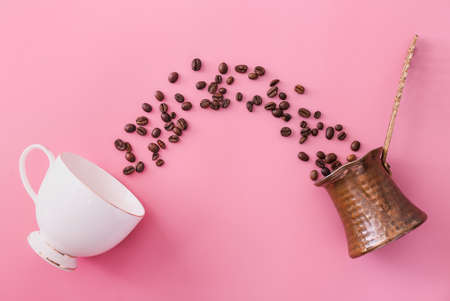Cup, coffee beans and jezve on color background