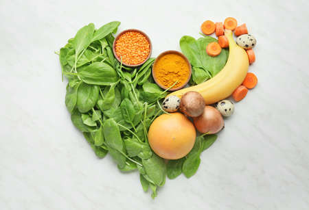 Healthy products in shape of heart on white backgroundの写真素材