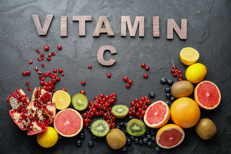 Healthy products rich in vitamin C on dark backgroundの写真素材