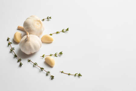 Garlic and herbs on white background