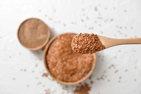 Spoon with flax seeds over tableの写真素材