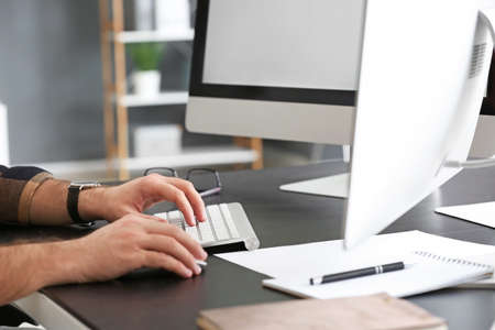 Male programmer working in office, closeup