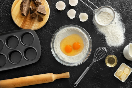 Ingredients for preparing bakery and utensils on dark backgroundの写真素材