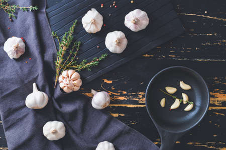 Fresh garlic with spices and herbs on tableの写真素材