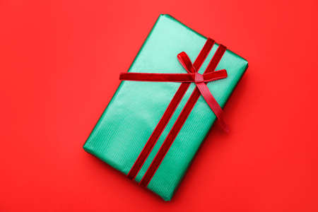 Packed gift on color background