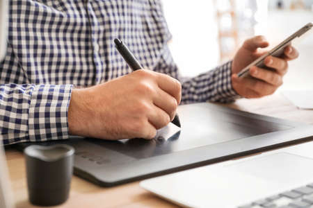 Male IT designer working in office, closeupの写真素材