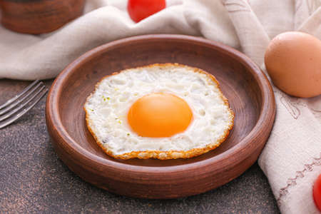 Plate with fried egg on dark backgroundの写真素材