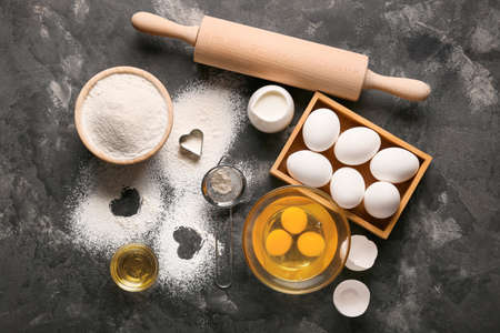Ingredients for preparing cookies on dark background