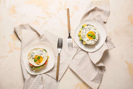 Sandwiches with fried eggs on white background