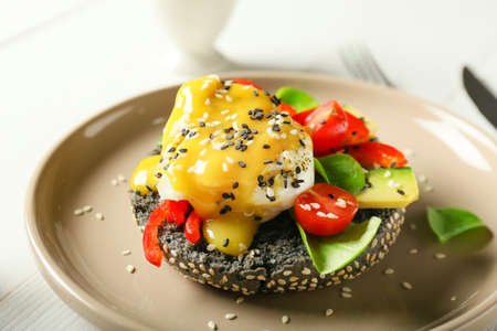 Tasty egg Benedict on plate, closeup