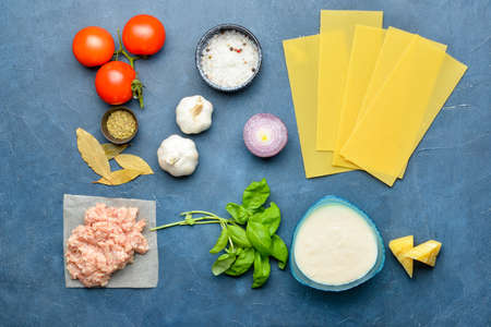 Ingredients for lasagna on color backgroundの写真素材