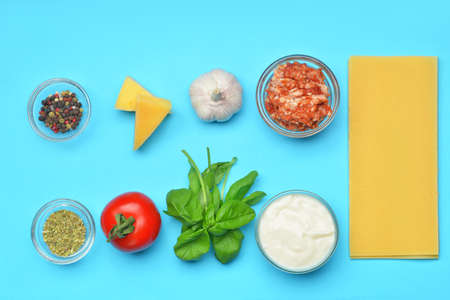 Ingredients for lasagna on color backgroundの写真素材