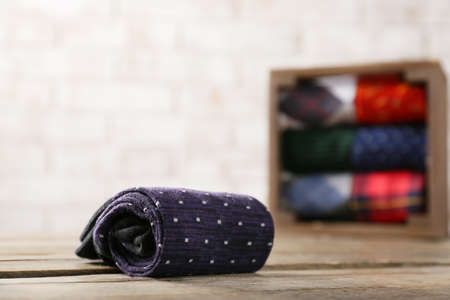 Rolled socks on wooden tableの写真素材