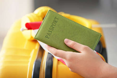 Woman with passport, Canadian flag and luggage, closeup. Travel and immigration conceptの写真素材