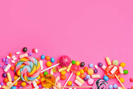 Assortment of tasty candies on color background