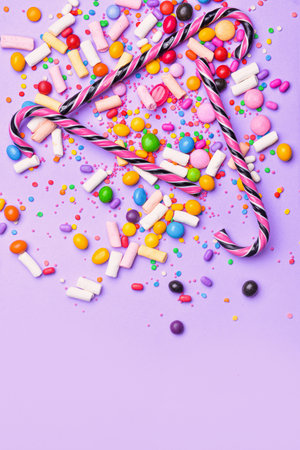 Assortment of tasty candies on color backgroundの写真素材