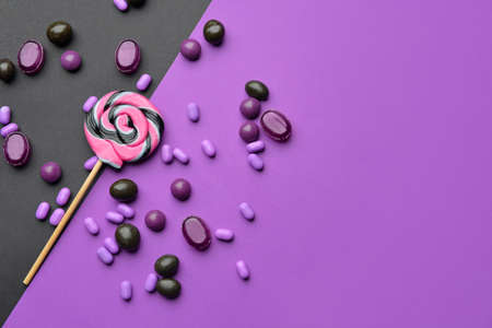 Assortment of tasty candies on color backgroundの写真素材